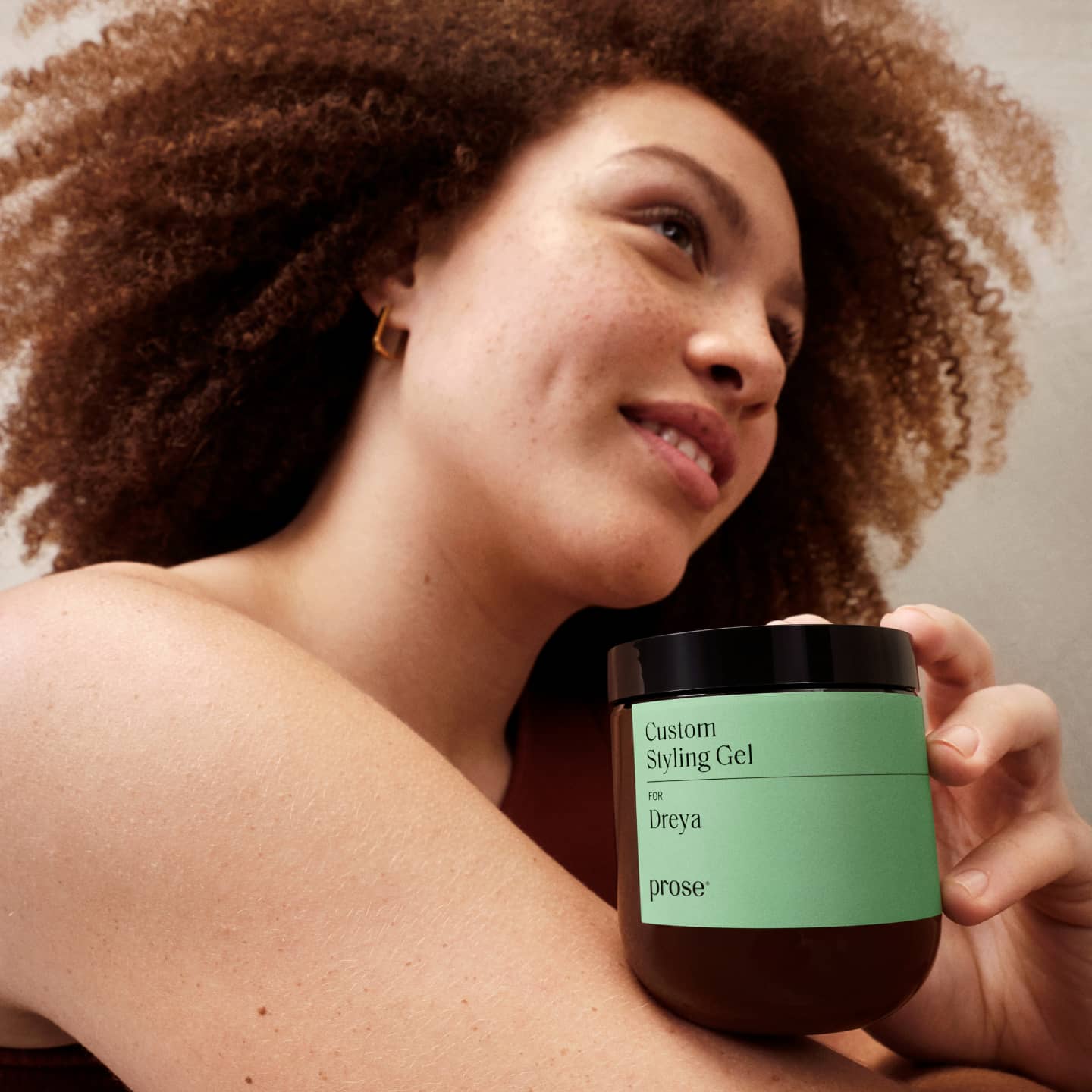 Prose model posing with container of custom styling gel