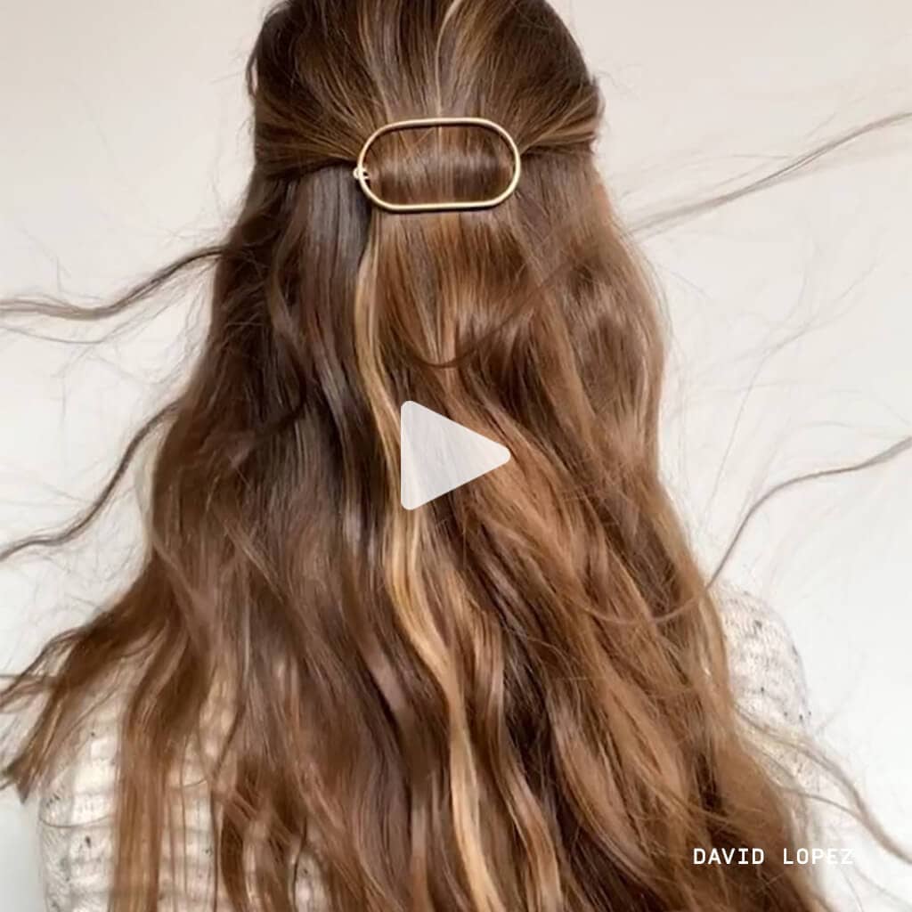 Video still of woman with long blonde hair blowing in the wind